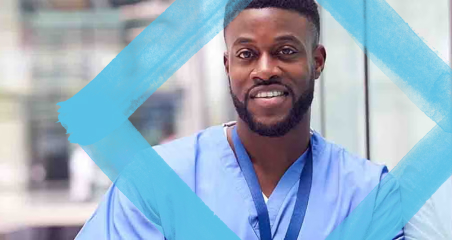 1. A man wearing scrub clothes smiles warmly, conveying a sense of friendliness and professionalism.
