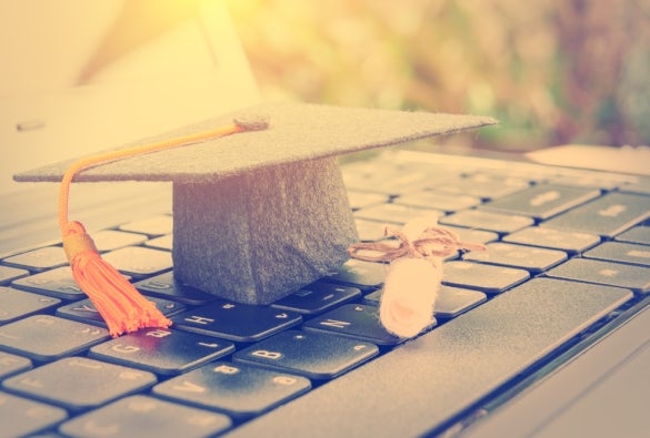 An MBA graduate cap on a laptop.