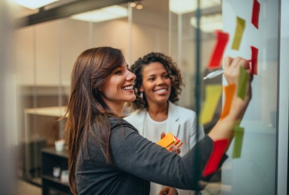 Change managers smiling and working together.