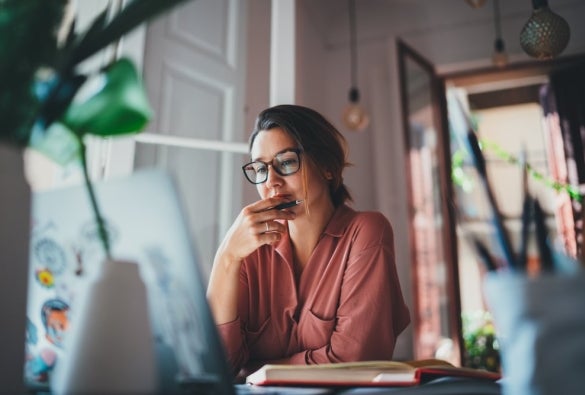 A woman planning her finances on her laptop.