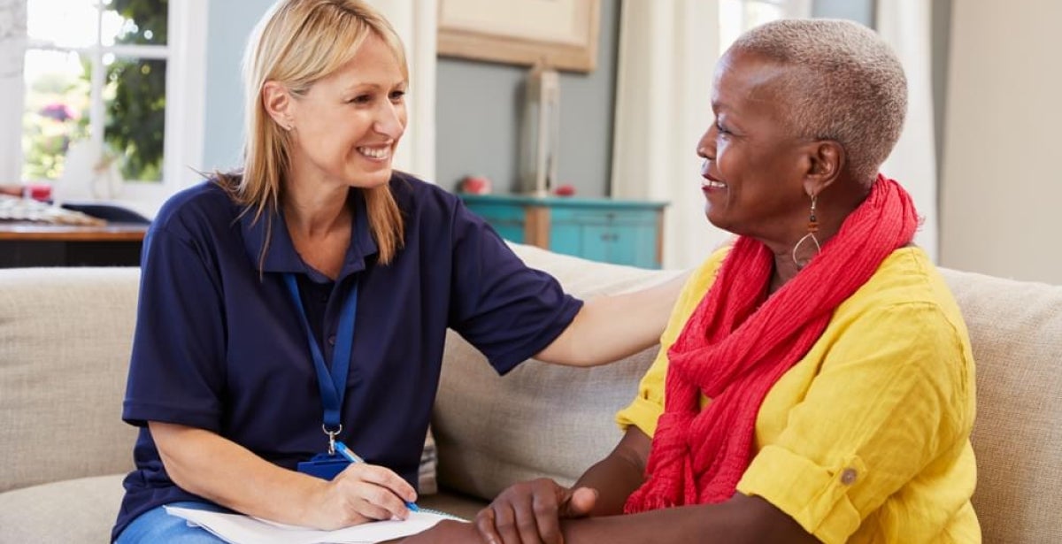A mental health worker talking with a senior woman
