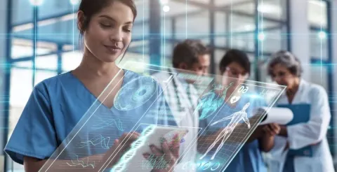 A nurse using a digital medical gadget to monitor a patient's health data.