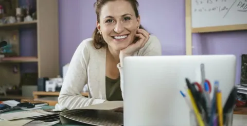 Satisfied woman celebrating study goals and maintaining motivation throughout her academic learning period.