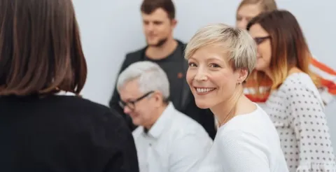 Healthcare professional smiling at the camera while discussing the importance of global health initiatives.