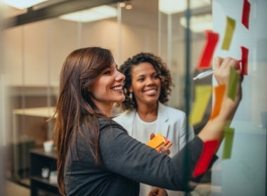 Change managers smiling and working together.