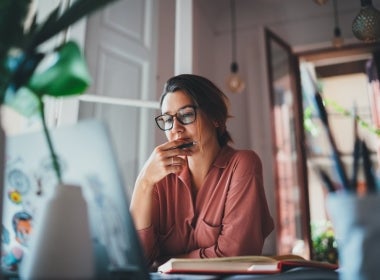 A woman planning her finances on her laptop.