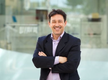 An MBA standing proudly with arms crossed.