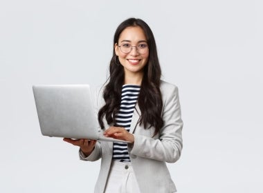 Financial planner holding a laptop.