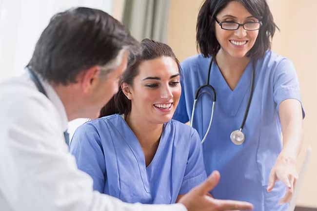A healthcare student wearing a uniform standing confidently in a clinic.
